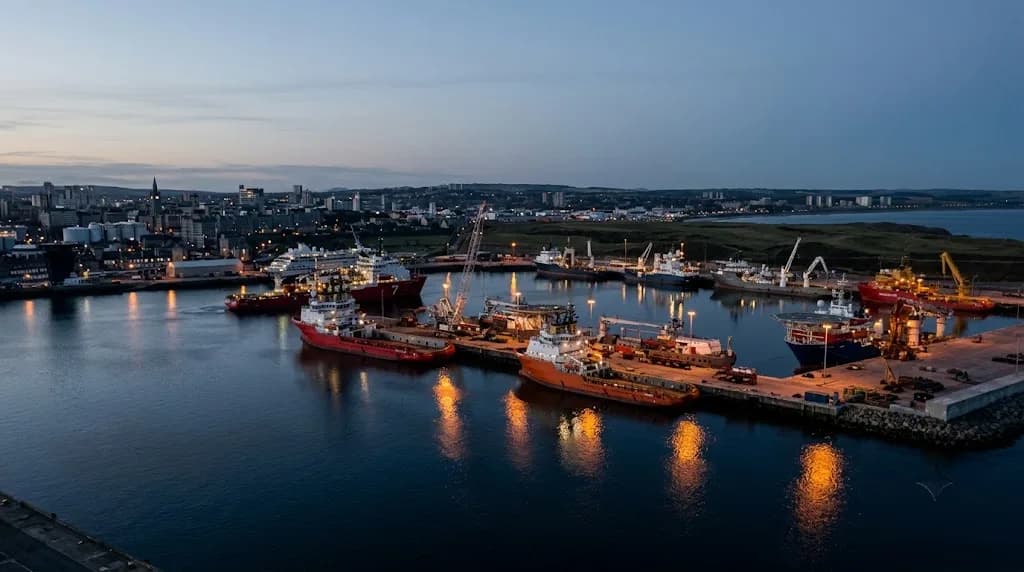 Aberdeen harbour at dusk with offshore supply vessels and granite city skyline, representing Aristral's digital marketing work for Aberdeen businesses