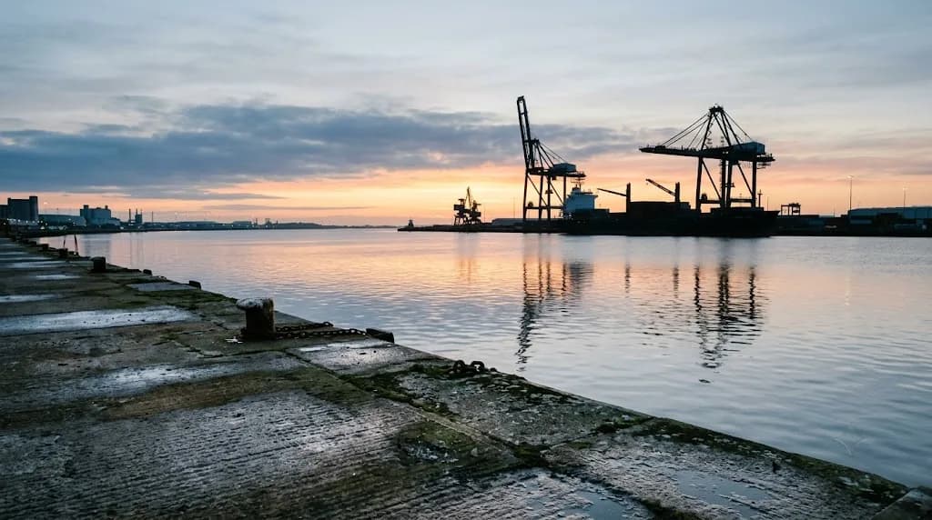 Humber estuary quayside at dawn with dock cranes and freight vessel representing Aristral's digital marketing work for Hull businesses