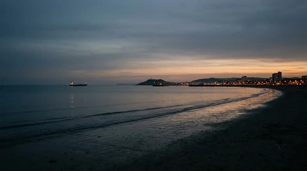 Swansea Bay shoreline at dusk representing Aristral's digital marketing work for Swansea businesses